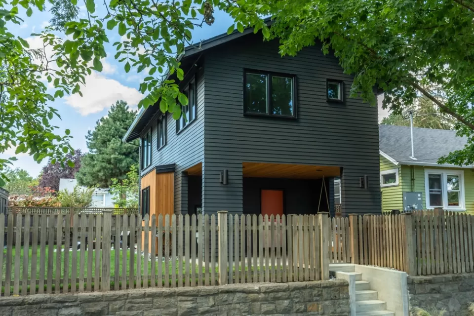 Dark grey two-story accessory dwelling unit in backyard